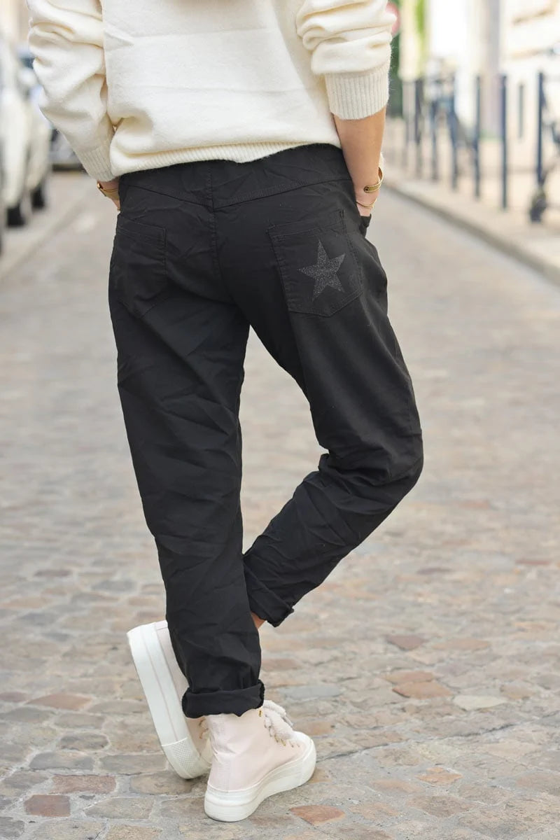 Black comfort and stretch fabric pants with a glitter star