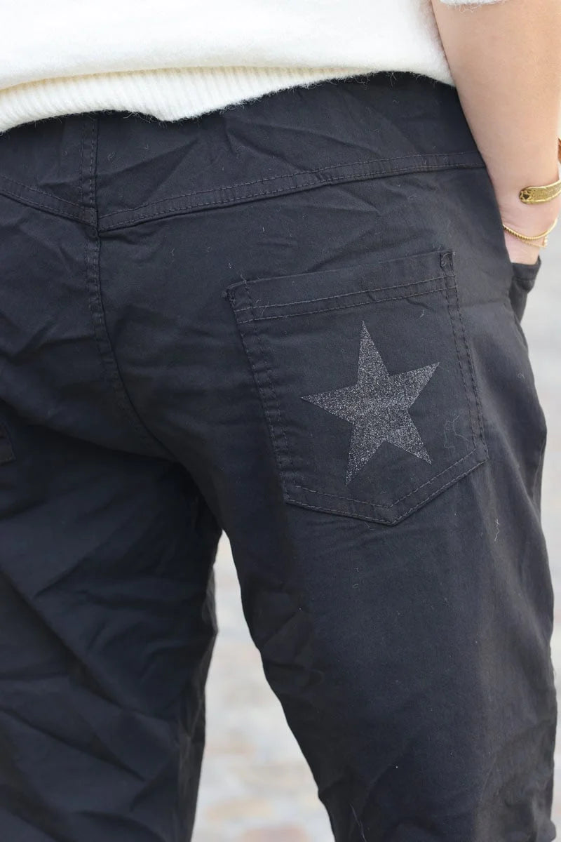 Black comfort and stretch fabric pants with a glitter star