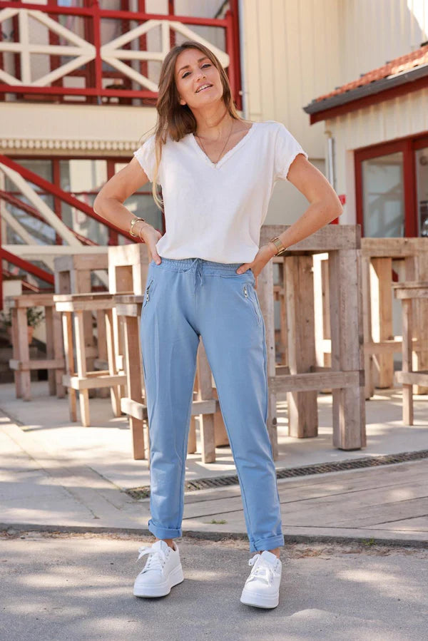 Blue stretch sweatpants with ribbon outseam zipped pockets