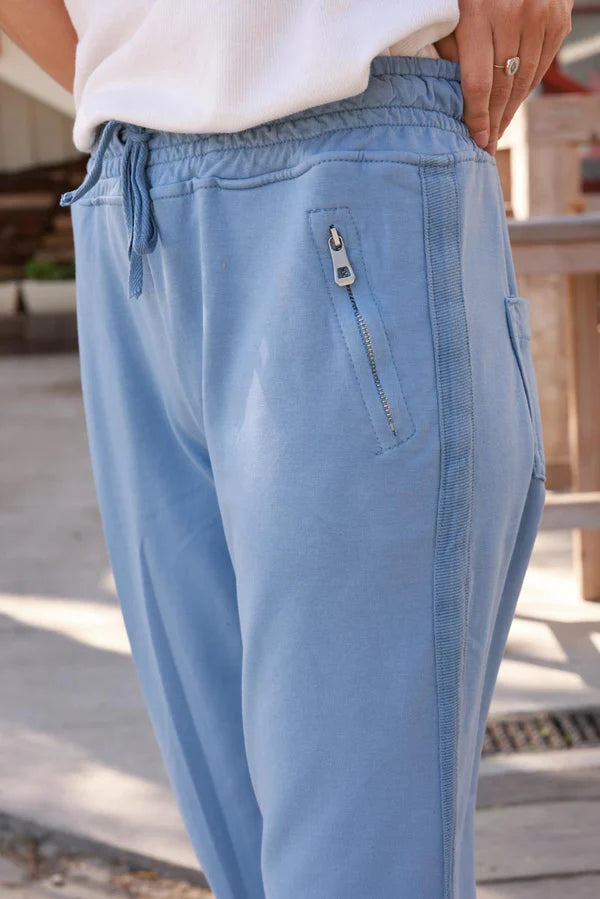 Blue stretch sweatpants with ribbon outseam zipped pockets