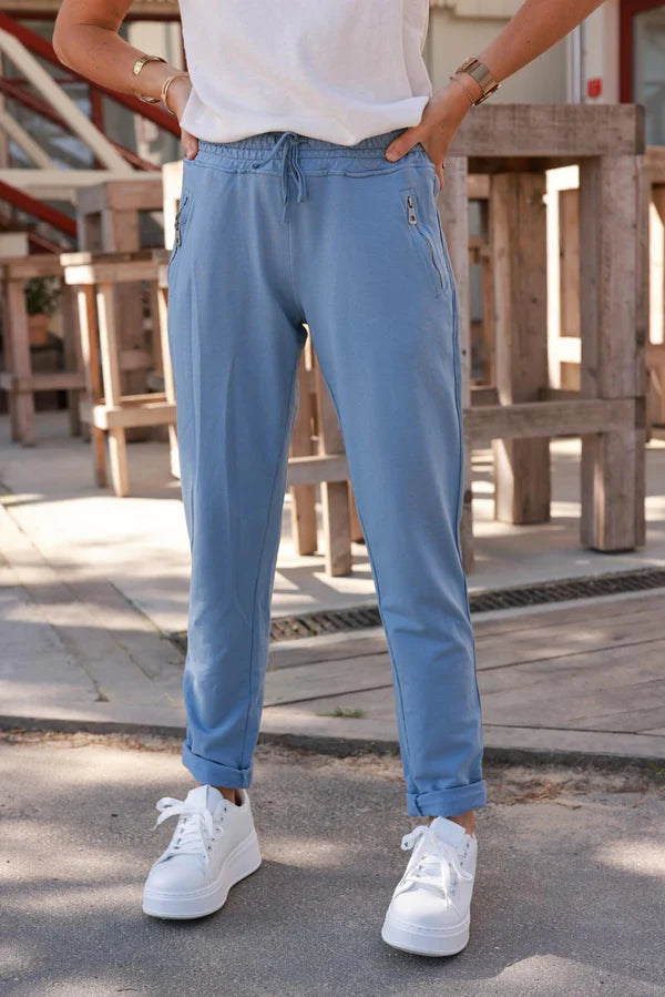 Blue stretch sweatpants with ribbon outseam zipped pockets