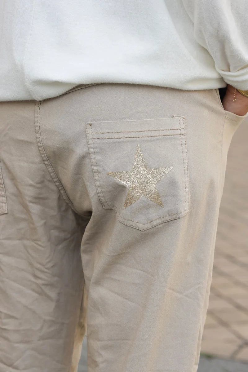 Beige comfort and stretch fabric pants with a glitter star