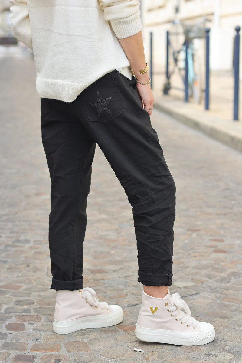 Black comfort and stretch fabric pants with a glitter star