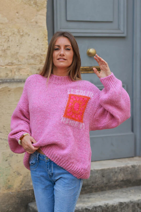 Pink chunky knit sweater with vibrant sun embroidery