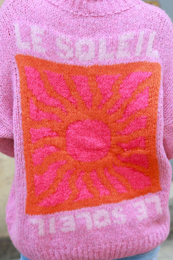 Pink chunky knit sweater with vibrant sun embroidery