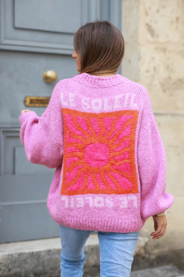 Pink chunky knit sweater with vibrant sun embroidery