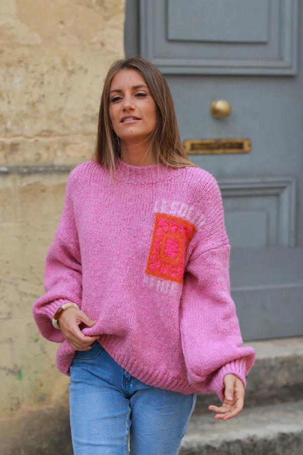 Pink chunky knit sweater with vibrant sun embroidery